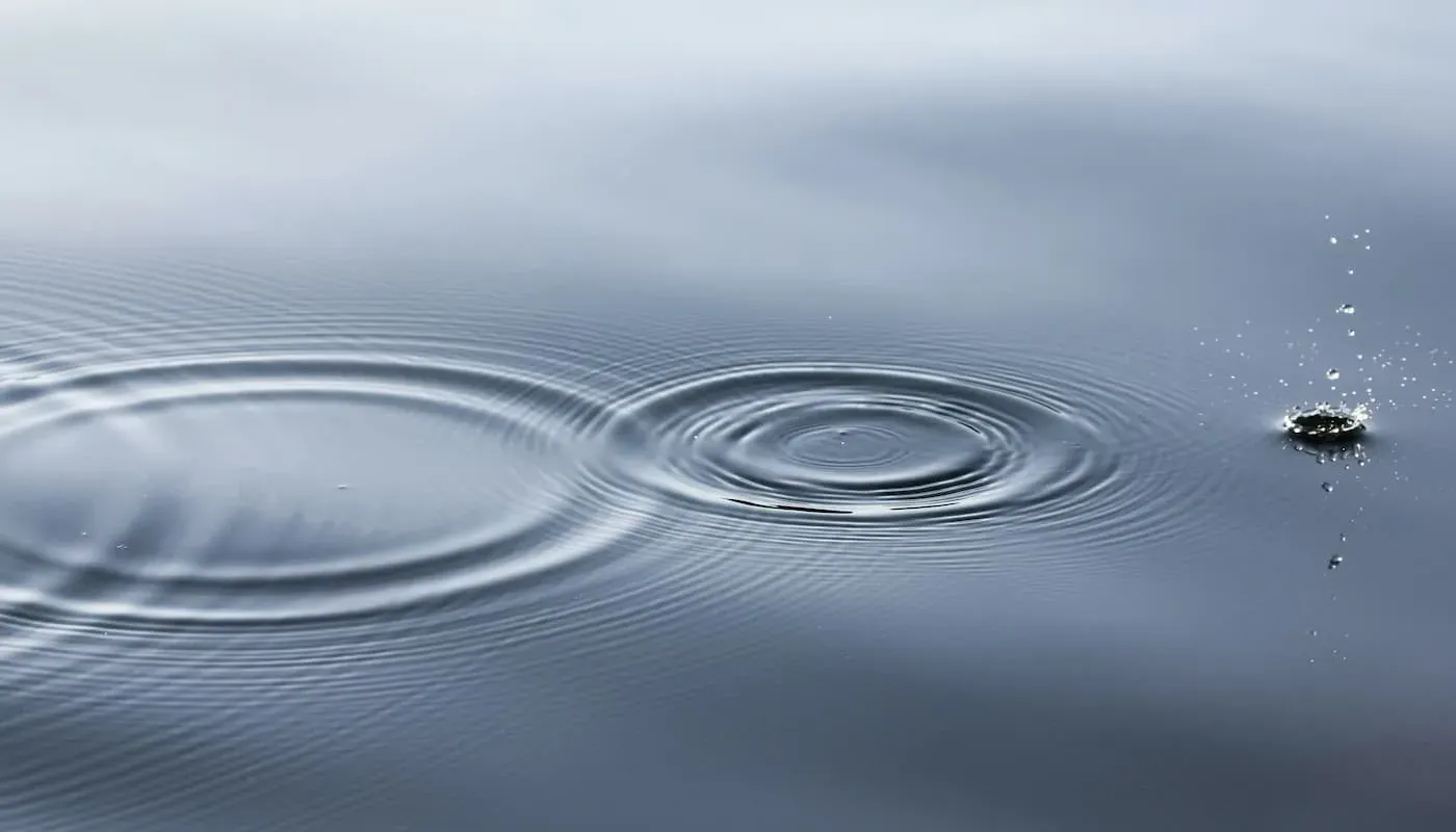 photo of stone skipping on water