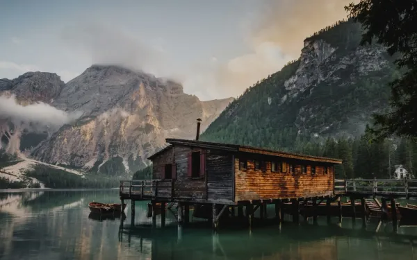 photo of a cabin next to mountains